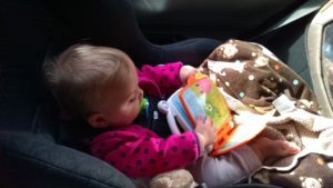 baby playing in carseat Providence Moms Blog