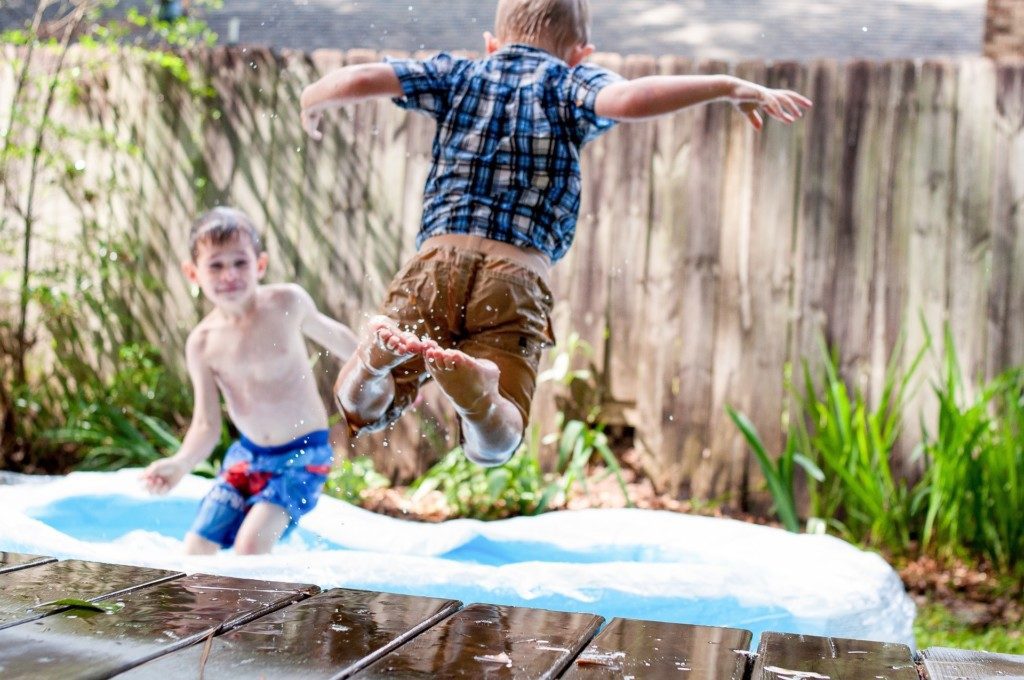 boys jumping into kiddie pool Providence Moms Blog