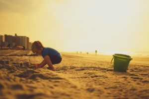 boy playing on beach Providence Moms Blog