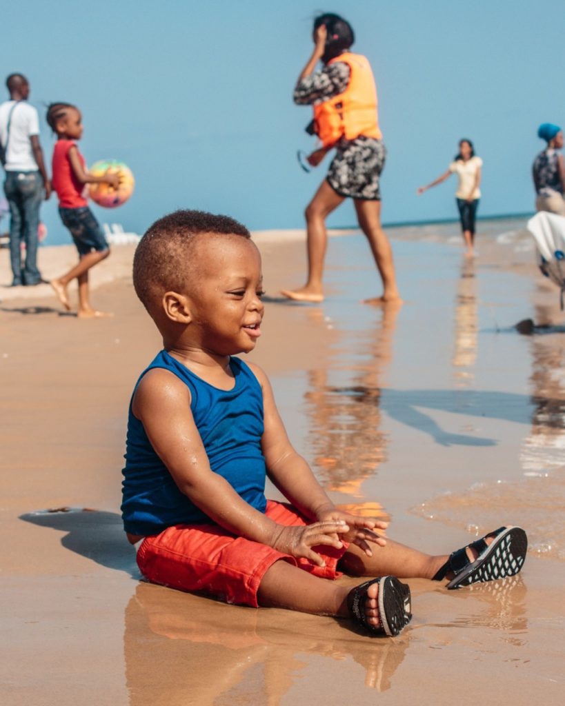 boy sitting on beach Providence Moms Blog