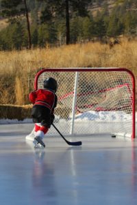 boy playing ice hockey Providence Moms Blog