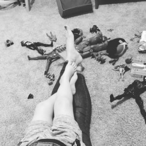toys and legs of mother and son in black and white Providence Moms Blog
