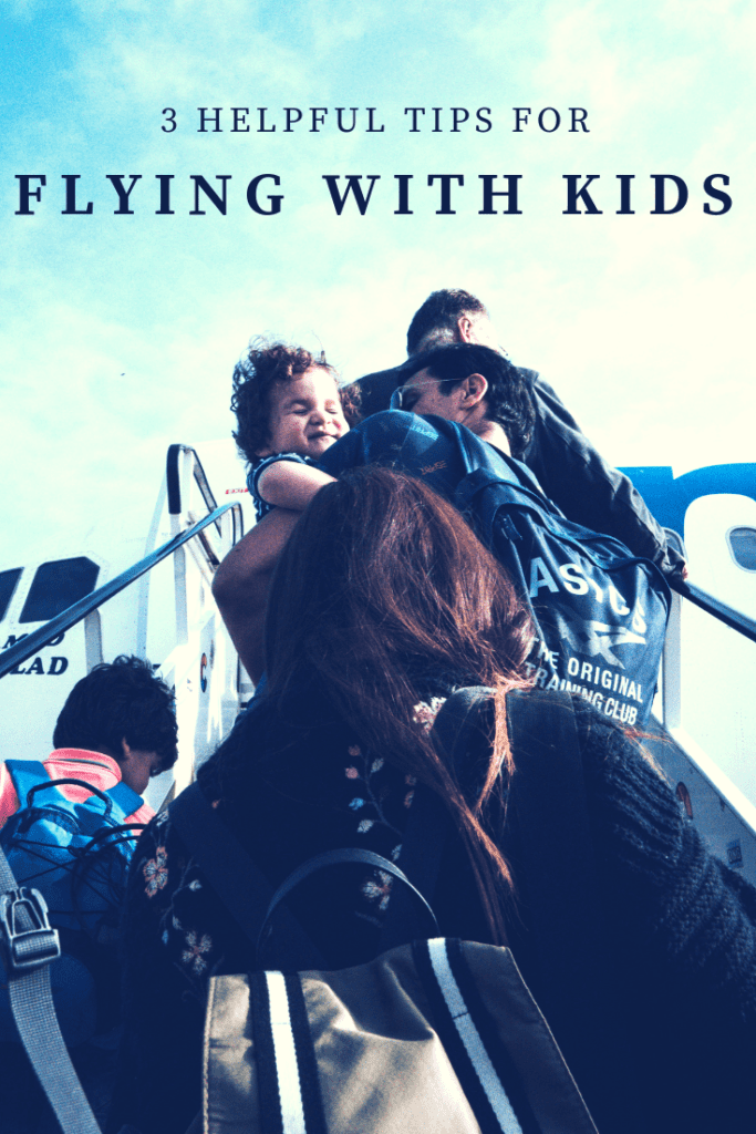 family boarding airplane from stairs Providence Moms Blog