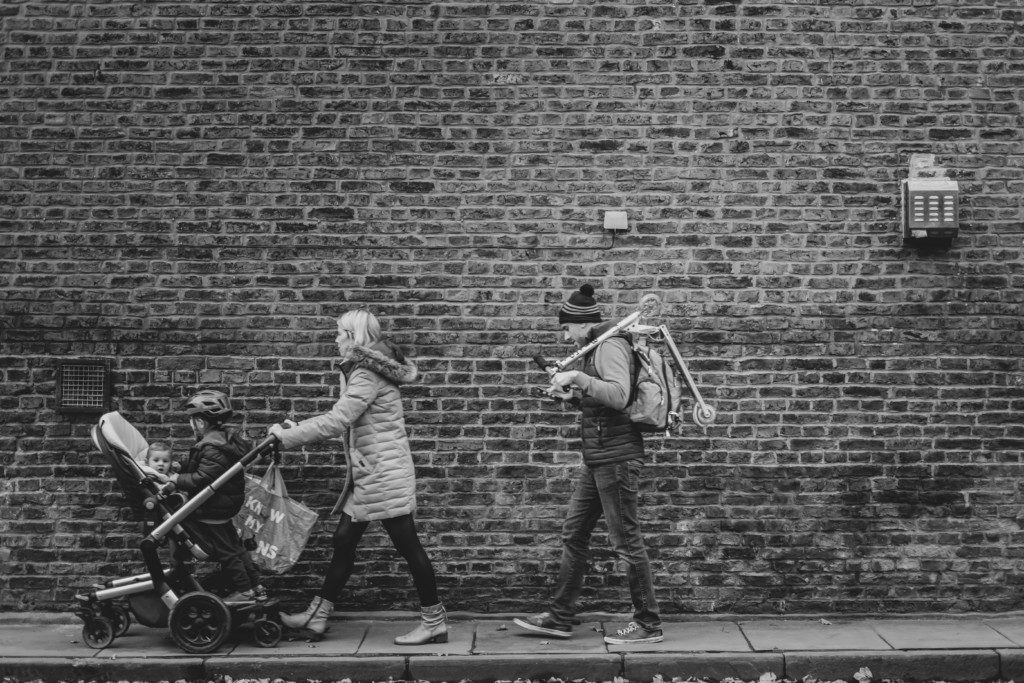 family walking against a brick backdrop