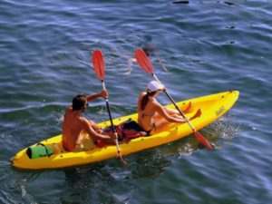 couple kayaking in open water