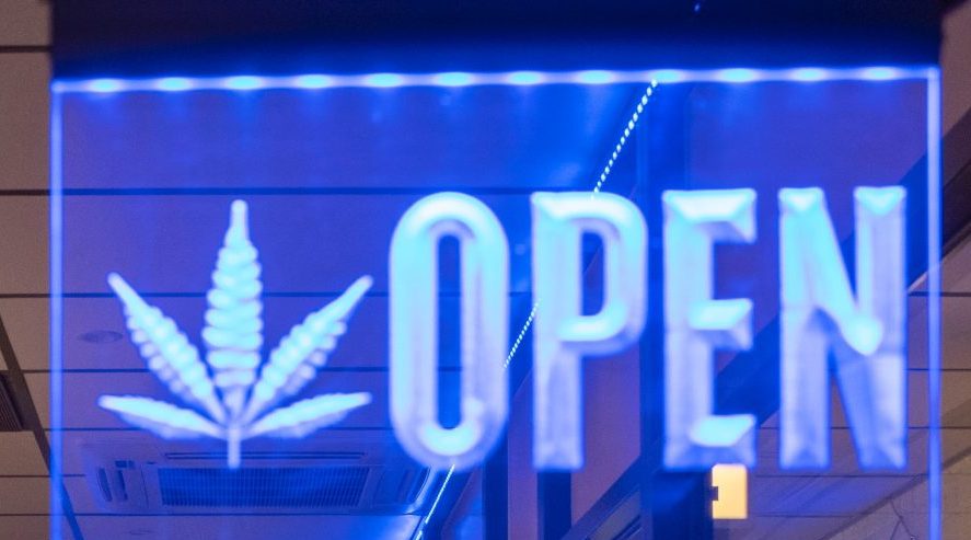 Marijuana Dispensaries in Rhode Island: RI Marijuana dispensary is open. Neon open sign with a pot leaf in blue