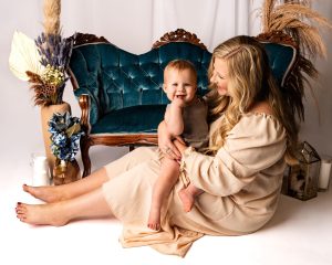 mom and child in front of blue sofa