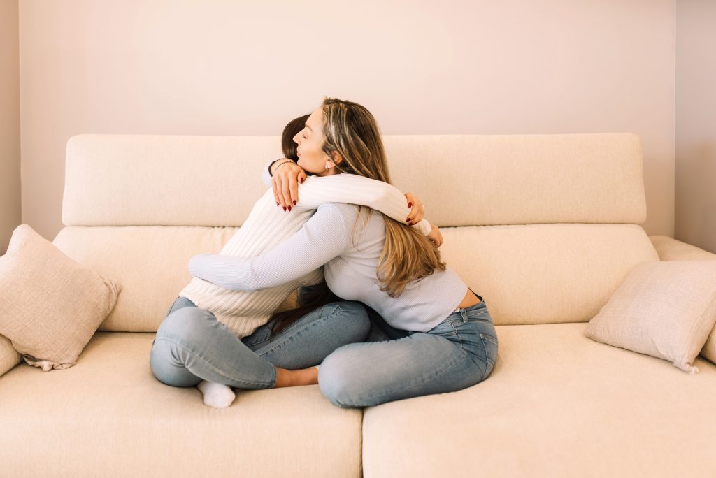 grieving mom giving woman hug