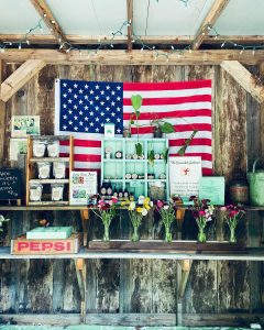 Stocked farm stand with American flag
